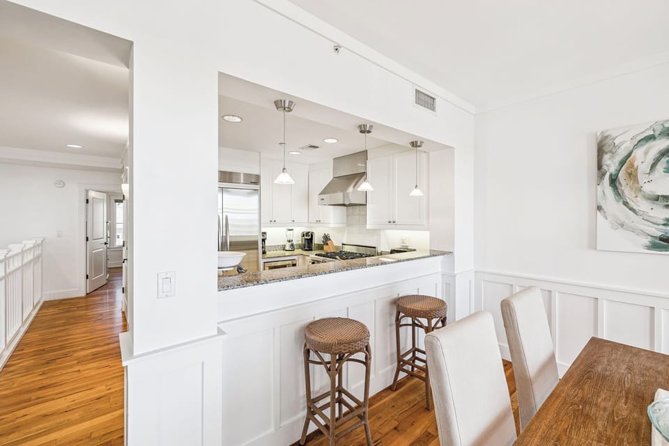 Your open-concept kitchen and dining area blends style with function—stainless appliances, granite counters, and a breakfast bar where you can sip coffee while planning your day.