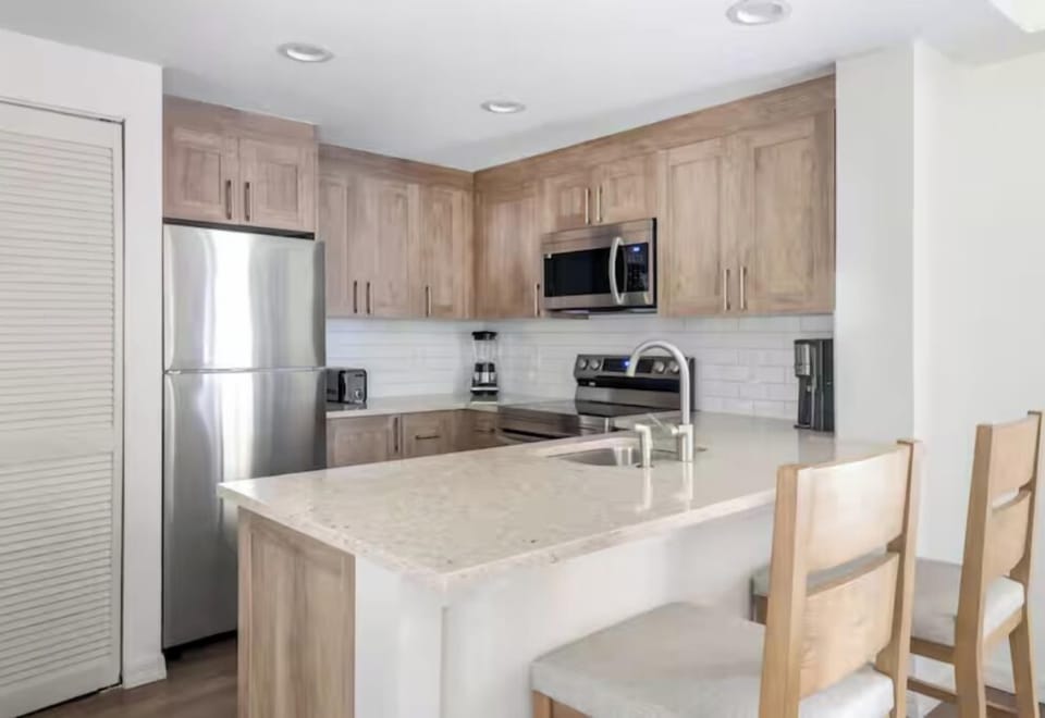 Cook with ease in a sleek kitchen with quartz island.