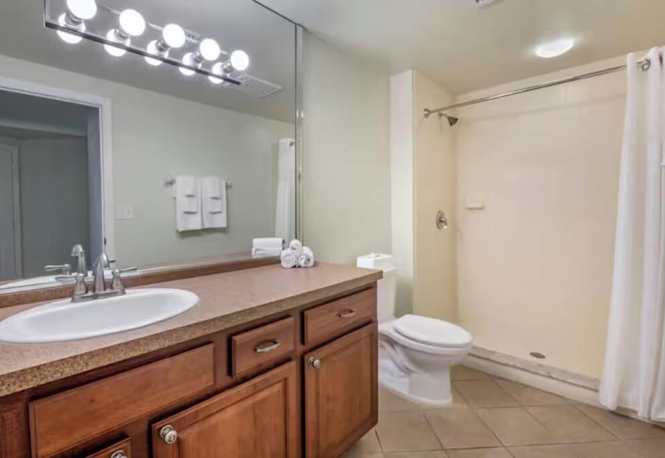 Refresh under bright vanity lights with fluffy towels ready.