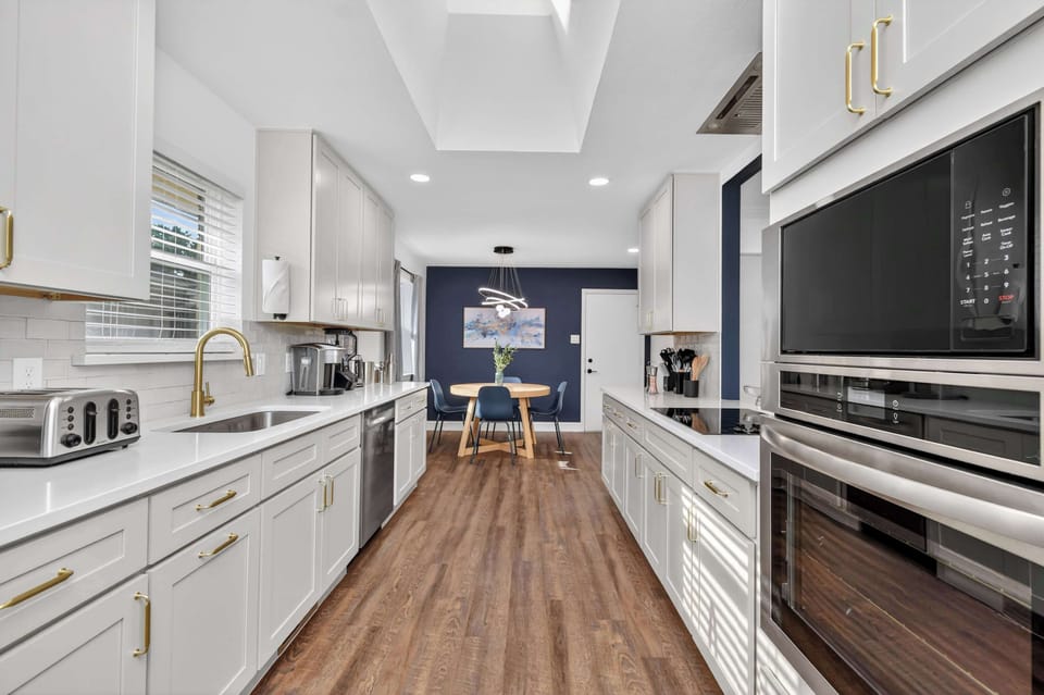 Chef’s kitchen with sleek finishes, double ovens, and a sunny breakfast nook—perfect for cooking, gathering, and starting the day right.