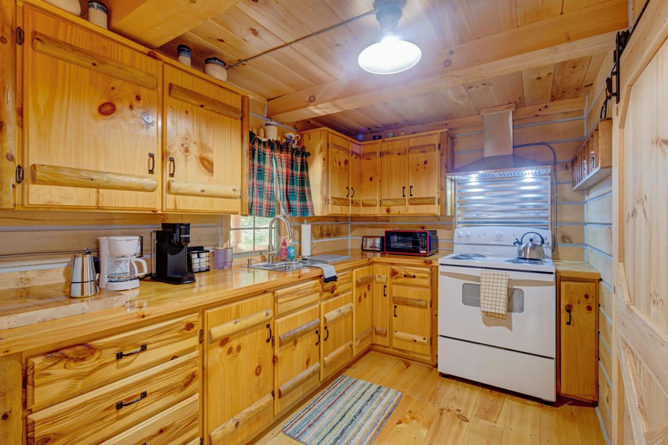 Cozy rustic wood kitchen with full appliances and charming cabin style