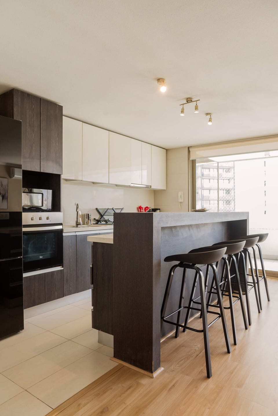 Sleek and modern kitchen with a cozy breakfast bar, perfect for enjoying meals with a view.