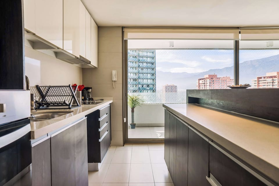 Enjoy cooking with stunning mountain views in this modern kitchen, complete with sleek cabinetry and ample natural light.