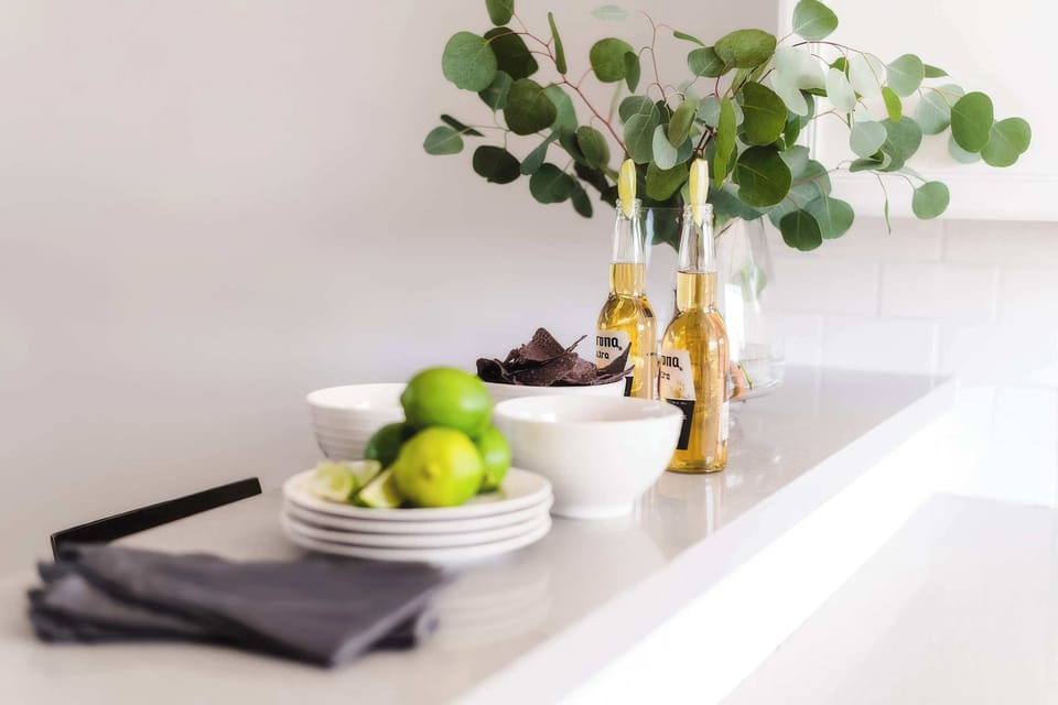Sleek, well-equipped kitchen with stainless steel appliances, ample prep space, bar seating, and everything you need for meals, snacks, and easy entertaining.
