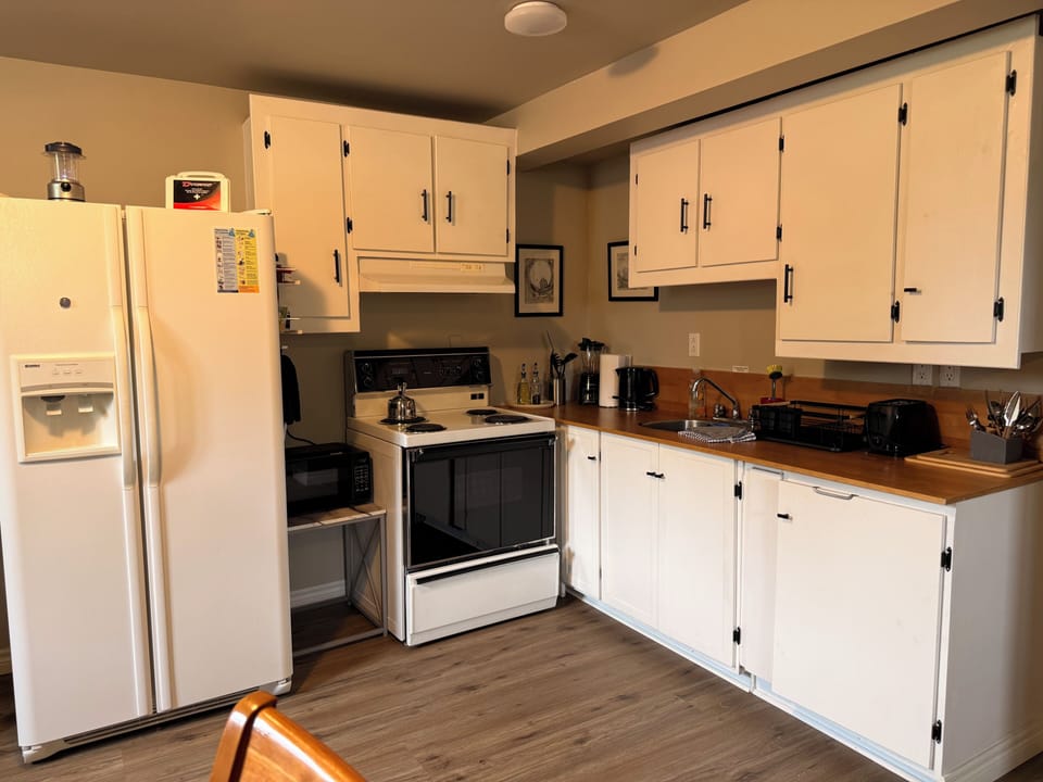 Spacious full kitchen with coffee maker, ample storage, and full-size appliances