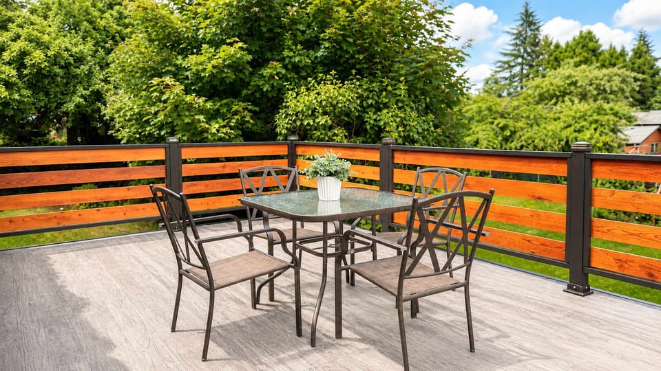 Relax on the private outdoor deck featuring comfortable patio seating and a vibrant, modern horizontal wood fence.