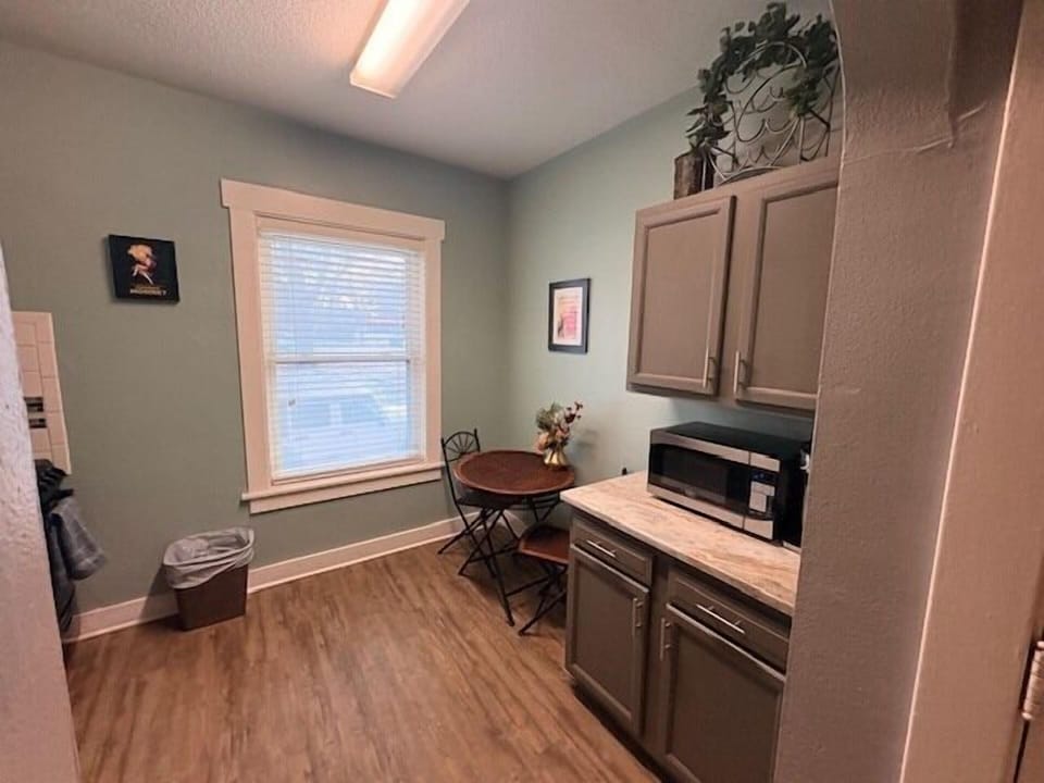 Cozy eat-in kitchenette with bistro table, microwave & sunlight