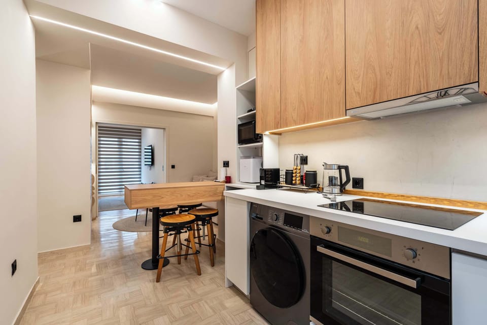 The fully equipped kitchen blends contemporary finishes with practical design, offering everything needed for preparing meals at home.