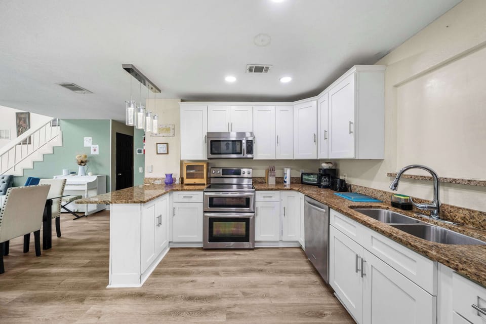 Modern kitchen with stainless appliances & granite counters