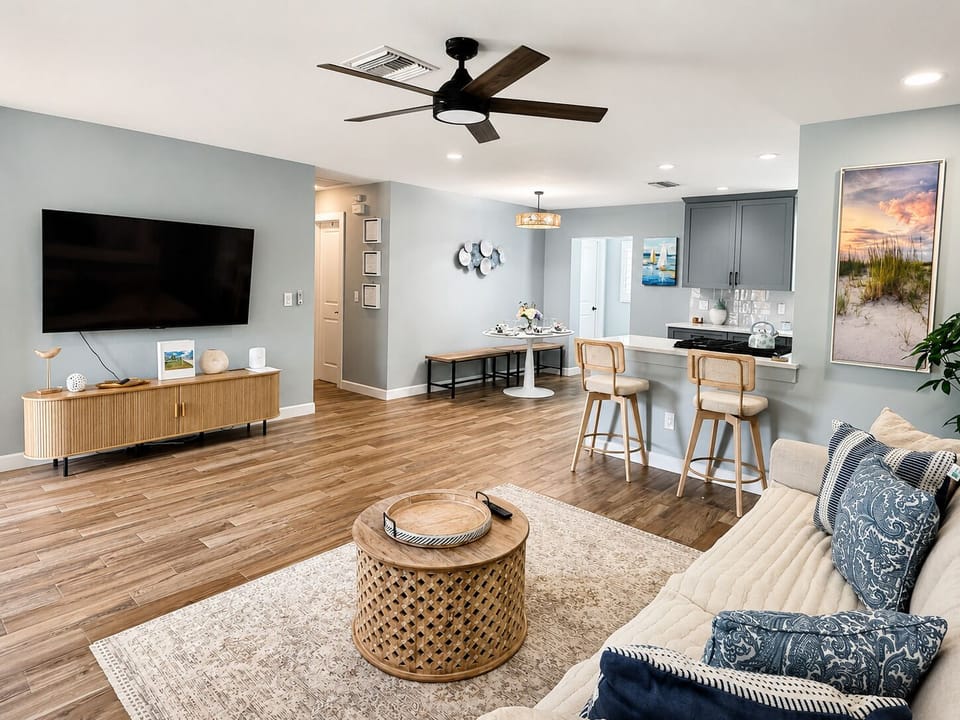 Bright open-concept living room with breakfast bar and coastal style