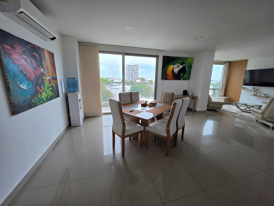 Sunlit open-plan dining & lounge with city views and AC