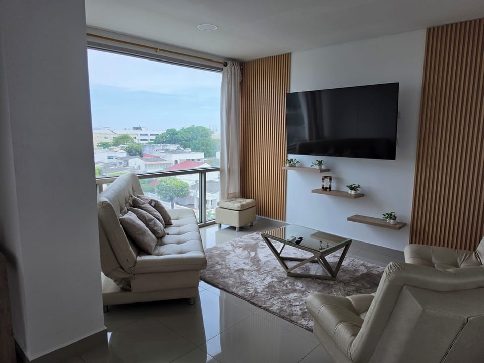 Sunny living room with city views, smart TV, and chic seating