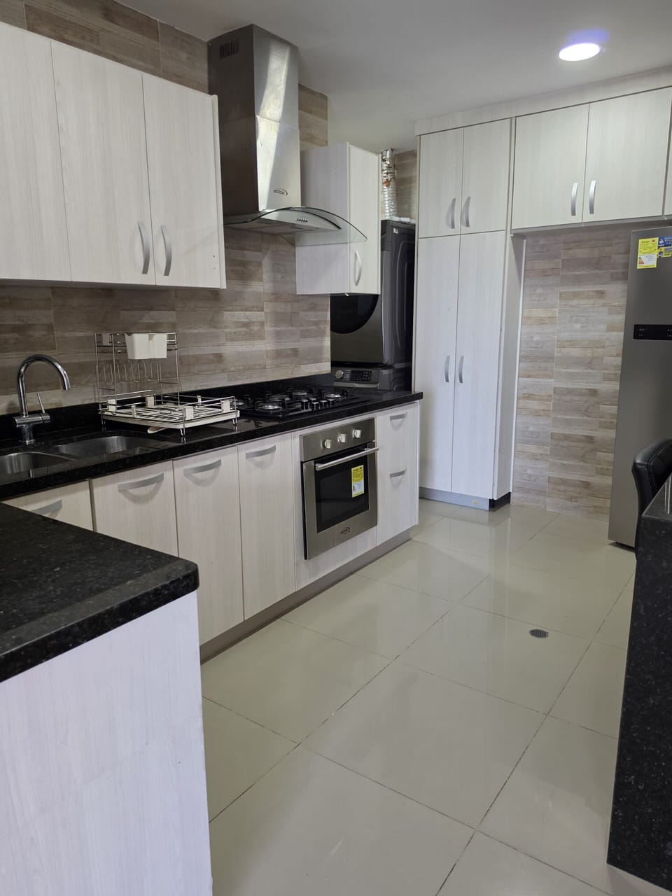 Modern kitchen with gas cooktop, granite counters & ample storage
