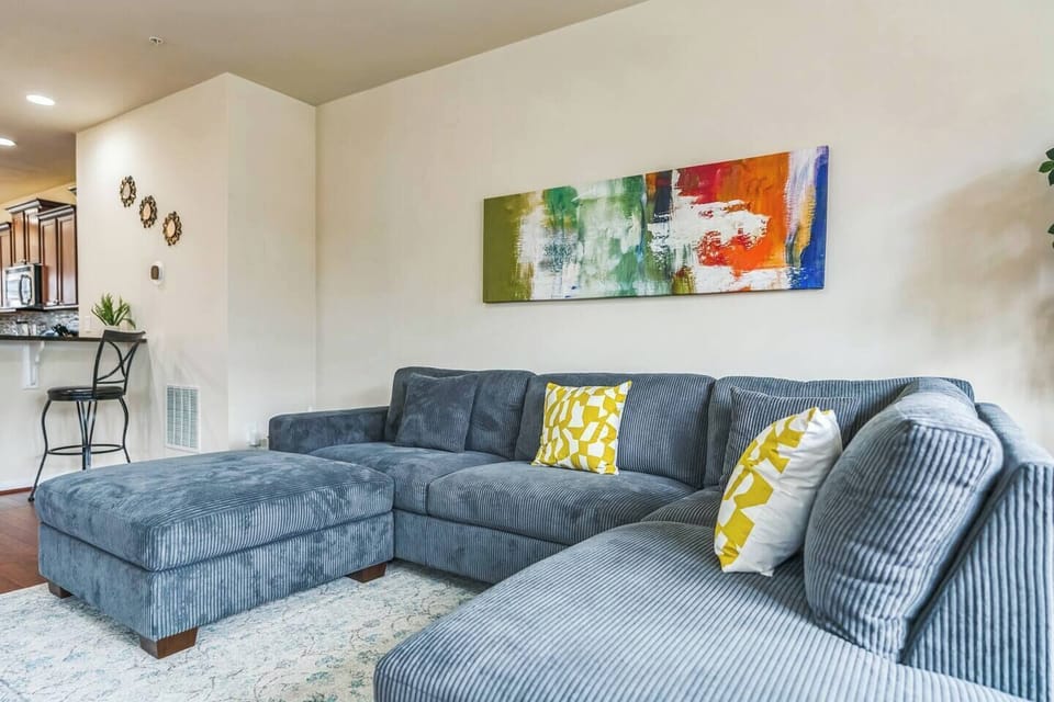 A bright and Cozy living room featuring a large sectional sofa for you to unwind after a long busy day. 