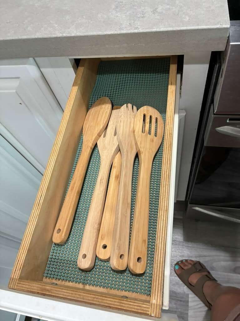 Well-stocked kitchen drawer with wooden utensils for easy home cooking