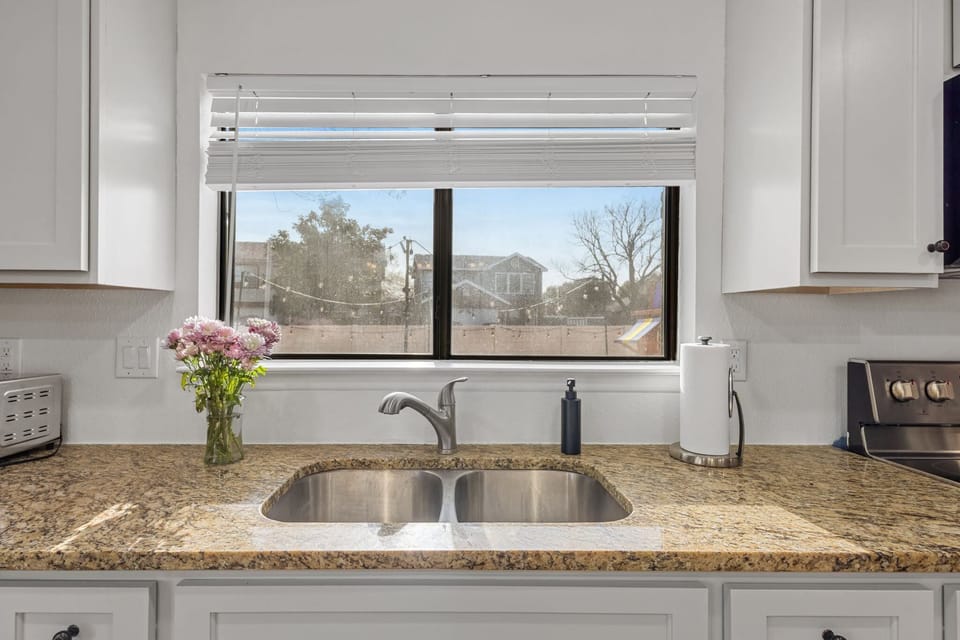 Kitchen sink with a window view of the backyard