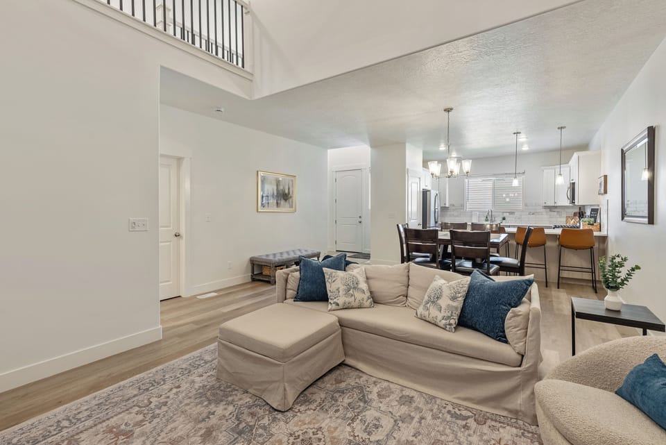 Bright open-concept living space with high ceilings and stylish kitchen