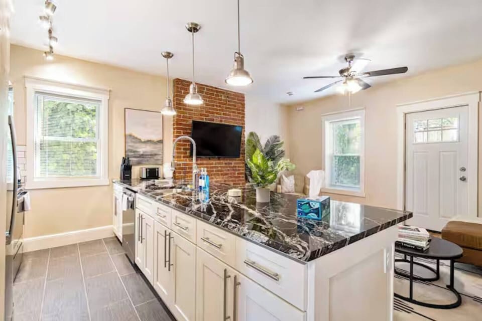 Gather, cook, and connect in this bright open-concept space, featuring a stunning island, modern amenities, and a cozy living area designed for unforgettable stays.