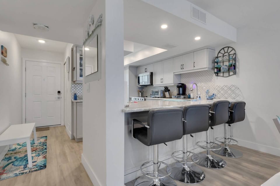Open to the dining and living areas, the kitchen creates a welcoming space where family and friends can gather throughout the day.