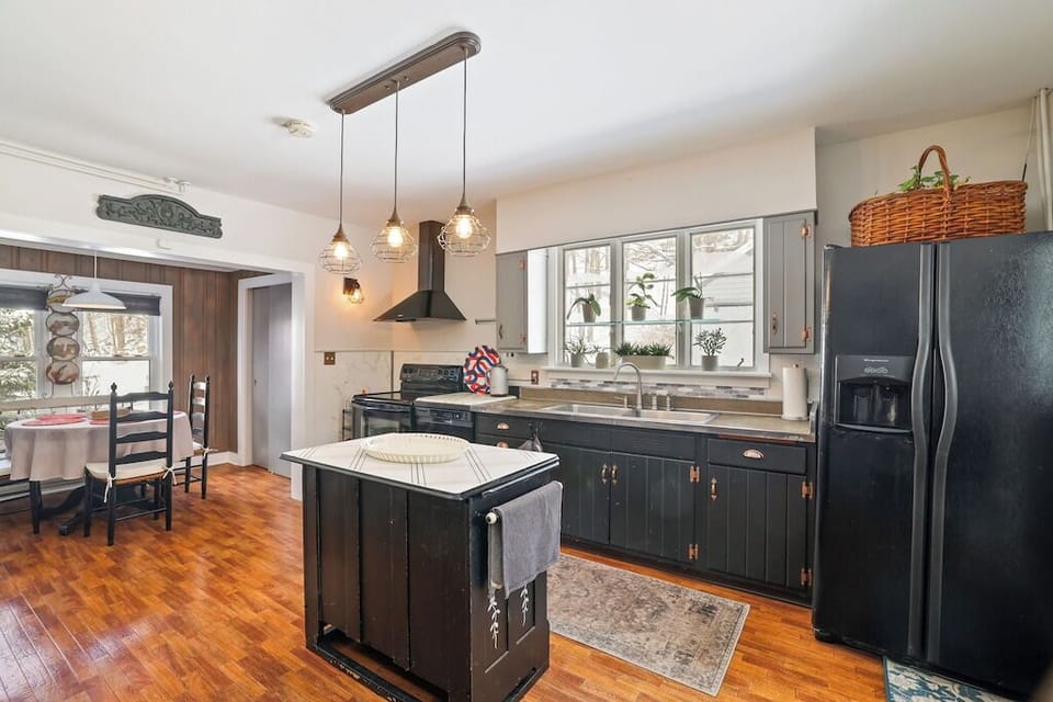 Bright kitchen layout featuring large window over sink, modern appliances, and a functional open cooking space.