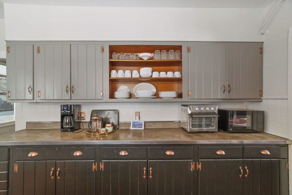 Modern kitchen with open shelving, stainless appliances, and organized prep space for easy cooking.