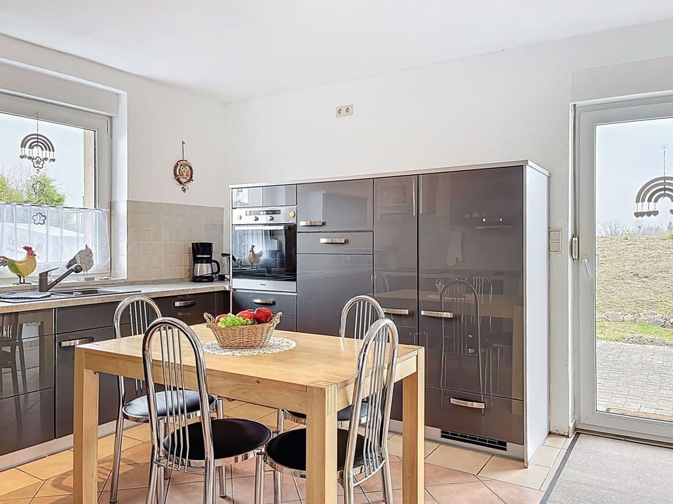 Furniture, Kitchen, Countertop, Interior Design, Flooring, Cabinetry, Kitchen Appliance, Chair, Floor, Wood