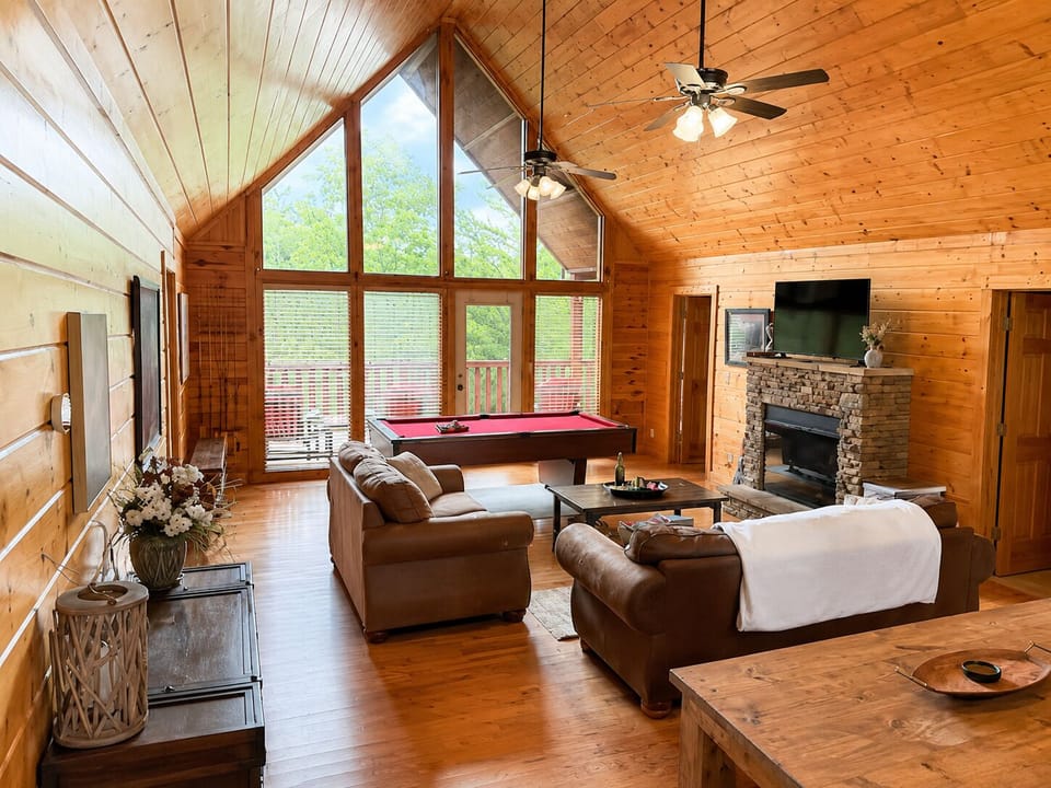 Open concept kitchen, dining table, and living room.  Pool table