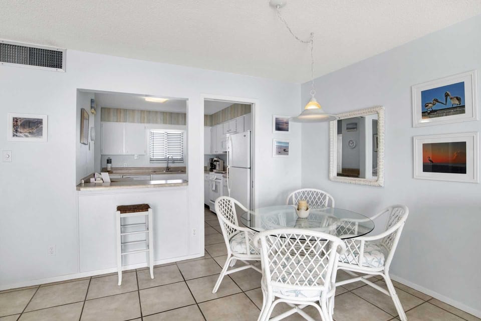 Bright dining area with cozy seating and open kitchen view