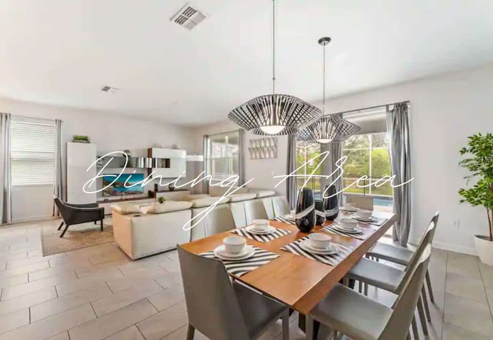 Dining Area: Stylish space for gatherings, featuring chic lighting and a view of the pool.