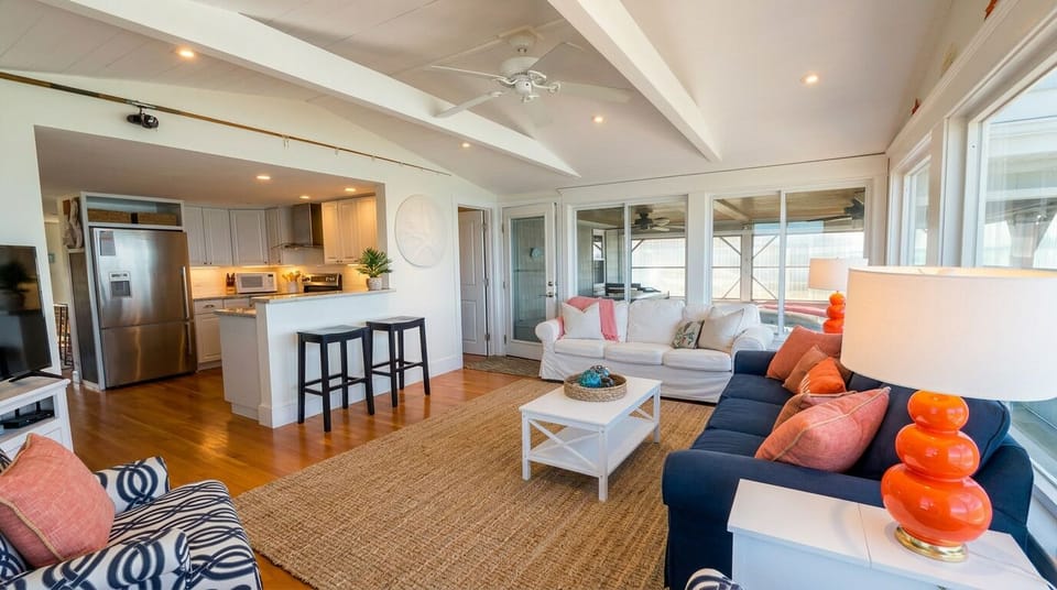 Bright coastal living room with open kitchen and inviting lounge seating