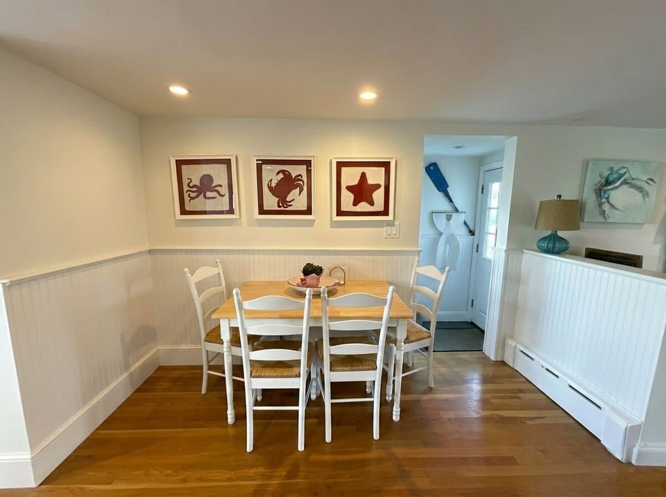 Bright coastal dining nook with beach decor and seating for four