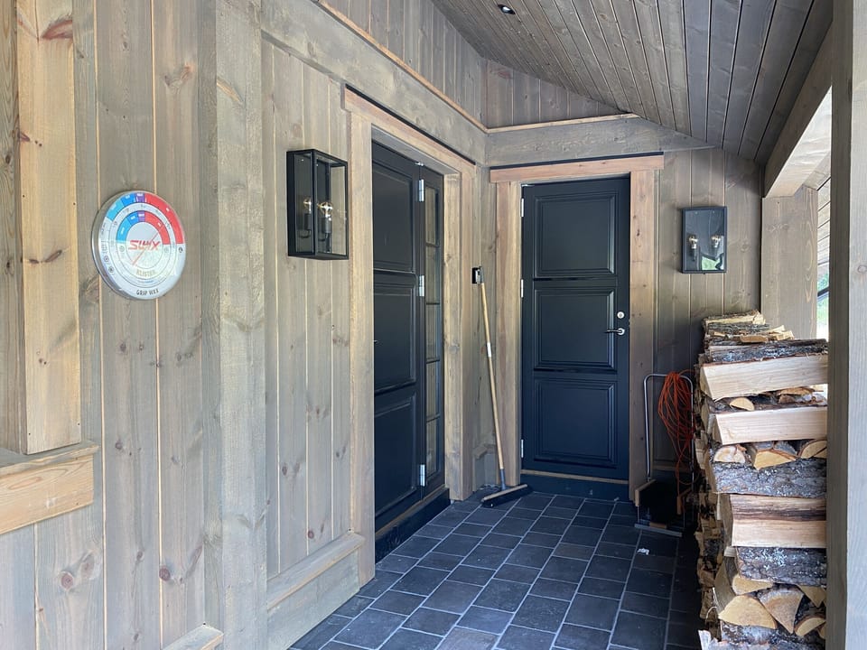 Welcoming cabin entry featuring timber beams and a mountain charm
