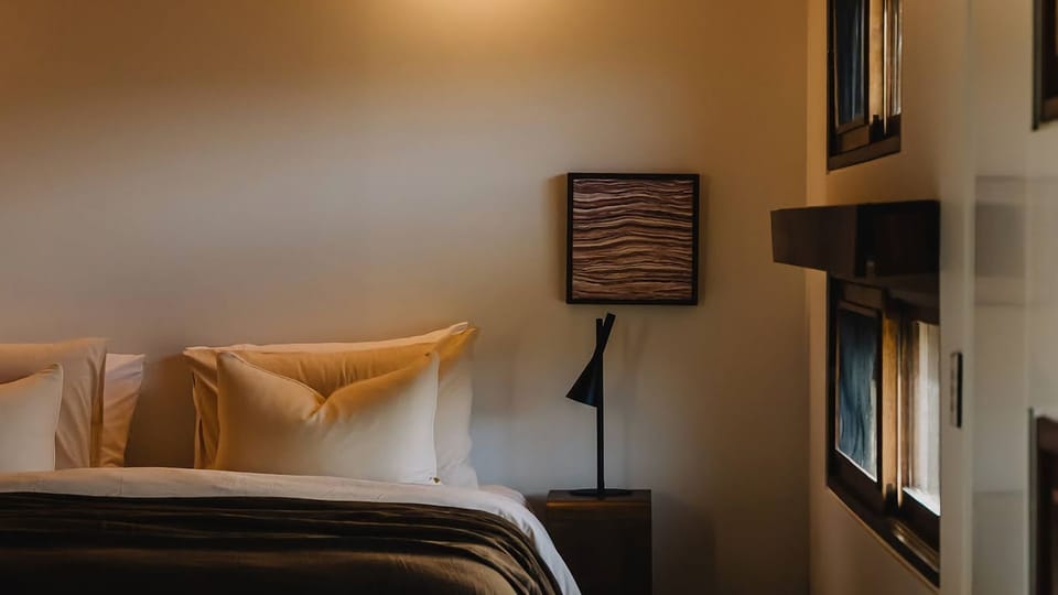 Bedrooms intentionally paired back - where natural materials, soft light, and a restrained palette create calm. 