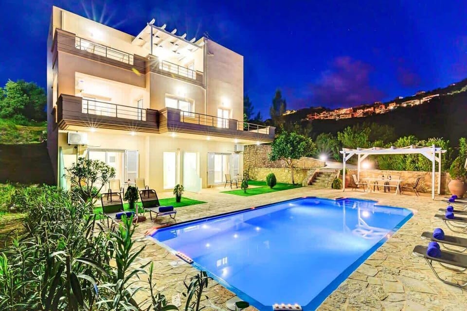 The property is beautifully lit in the evenings, creating a peaceful holiday setting.