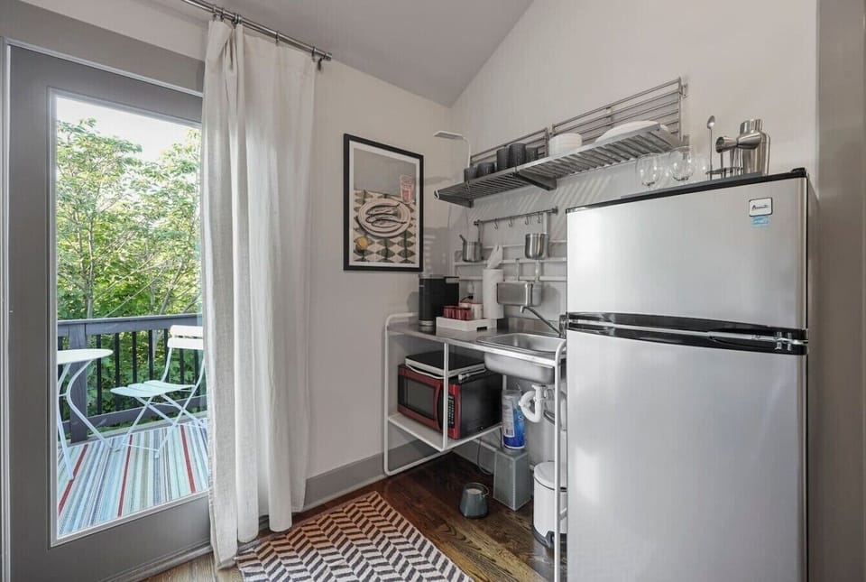 Functional kitchen featuring open shelving and a charming spot for meals.