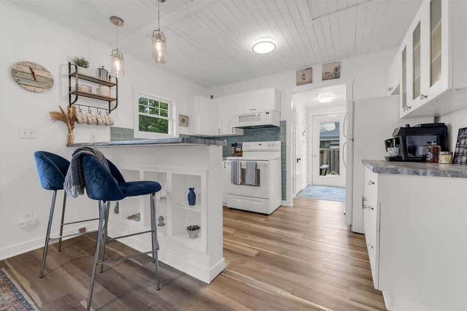 This fully equipped kitchen offers everything you need for a relaxing stay—from morning coffee at the breakfast bar to home-cooked meals. With modern touches, beachy accents, and plenty of natural light, it’s as functional as it is charming.