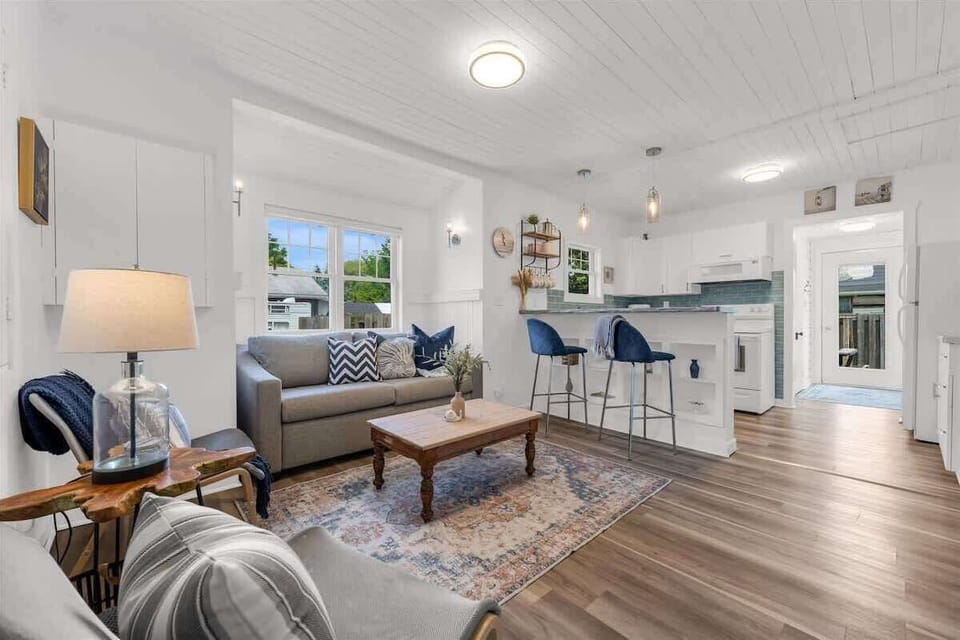 Step into a bright and airy open-concept living space, thoughtfully styled with coastal touches and cozy accents. Whether you’re sipping coffee at the breakfast bar or lounging on the plush sofa, this space is perfect for relaxing