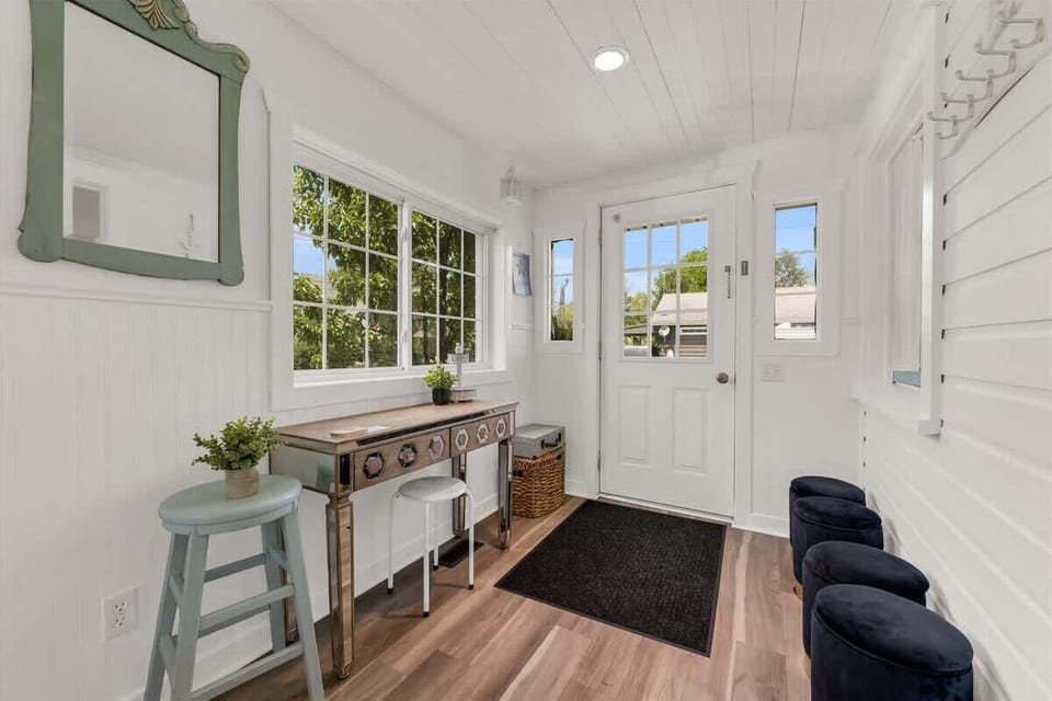 Step into a bright and welcoming entryway, perfect for dropping your beach bags and kicking off your shoes. With thoughtful seating, storage, and a touch of vintage charm, this space sets the tone for your relaxing stay by the lake.