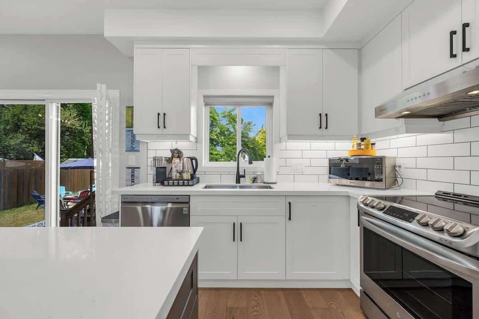Cook, connect, and unwind in this beautifully updated kitchen—featuring a fully stocked Kitchen, with pots, pans, cooking utensils, dishware, cutlery, spices, even an airfryer and rice cooker, coffee and tea station, dishwasher.