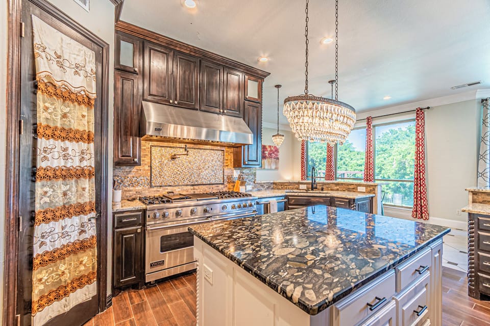 Enormous kitchen provides endless work space and great views to the outside and lots of seats for your cooking spectators