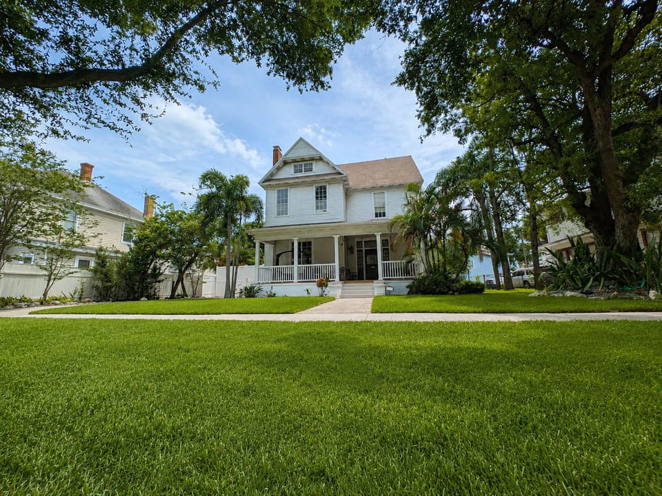 Looking at the house from the street during the daytime. 