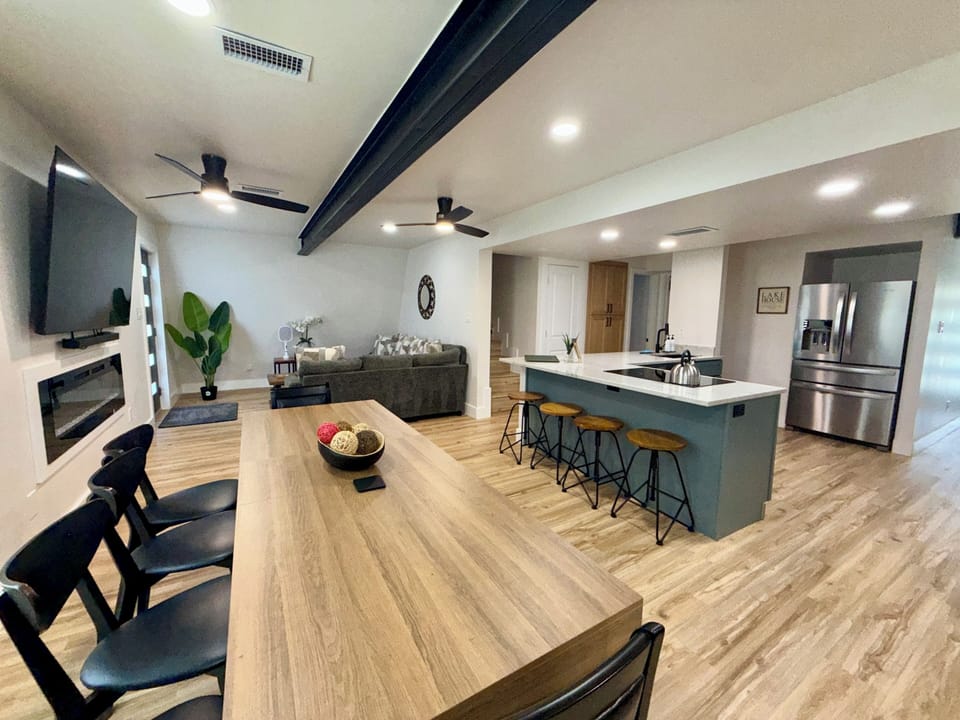 Spacious open-concept living with large island, dining table, and cozy lounge