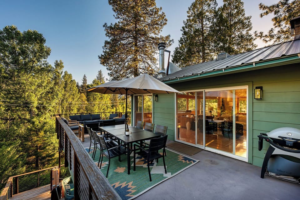 Private treetop deck with outdoor dining, lounge seating, and grill