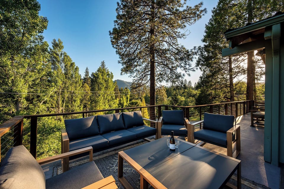 Private forest-view deck with stylish lounge seating