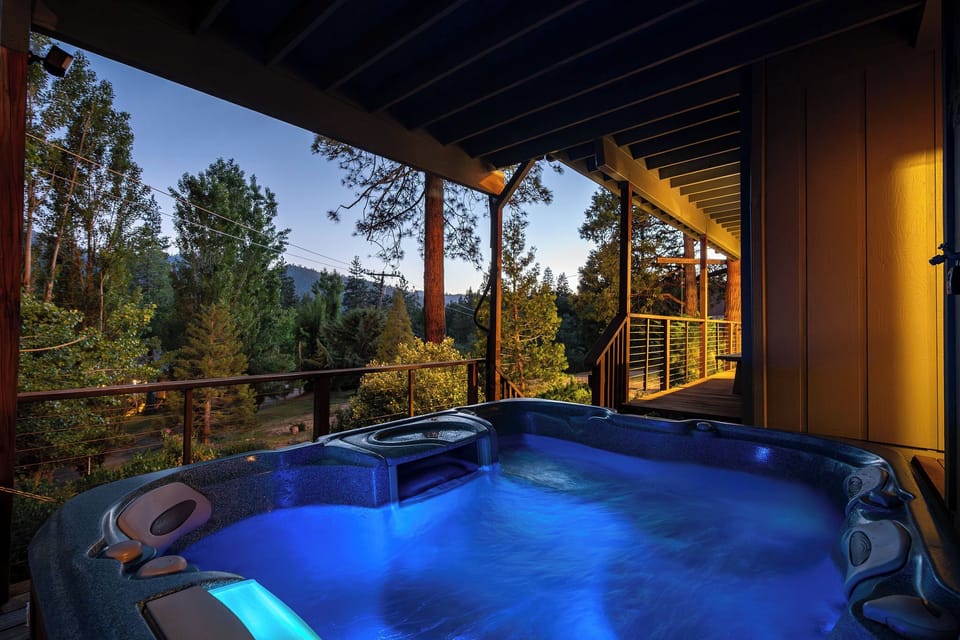Private forest-view hot tub on a cozy covered deck