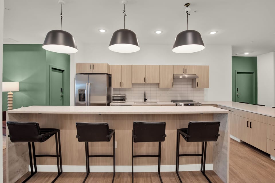 Modern kitchen with large island seating for 4 and sleek finishes