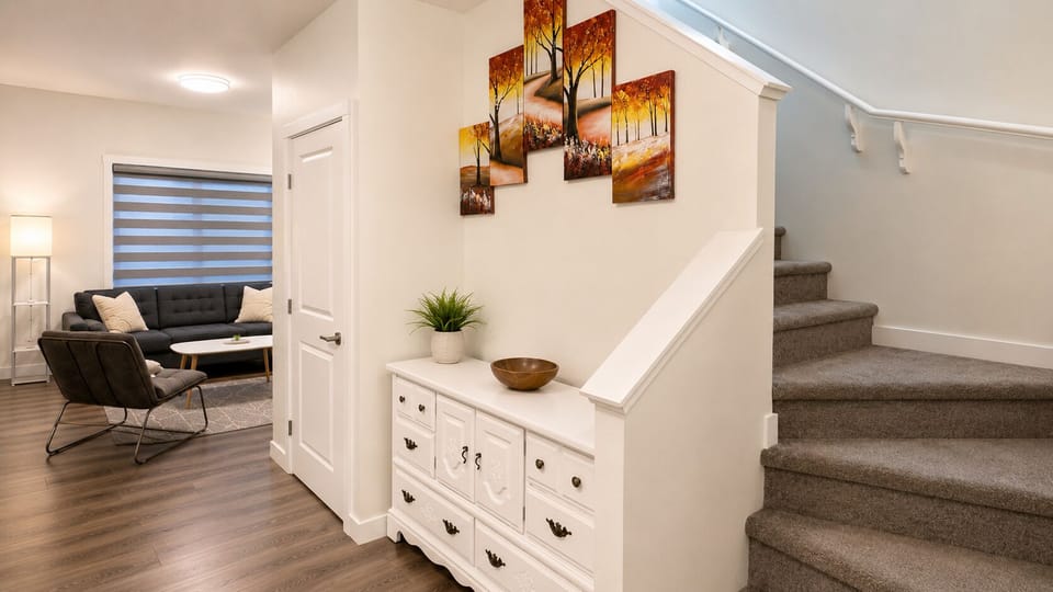Bright entryway with stylish decor, cozy lounge, and carpeted stairs