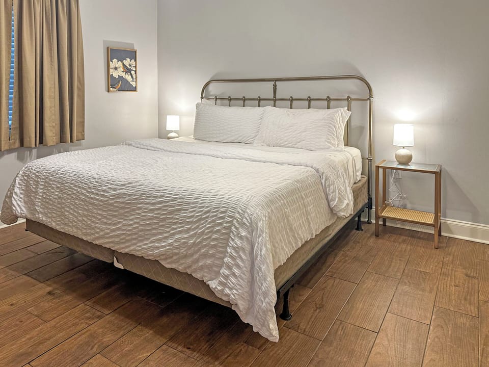 Cozy modern bedroom with king bed, soft lighting, and clean design