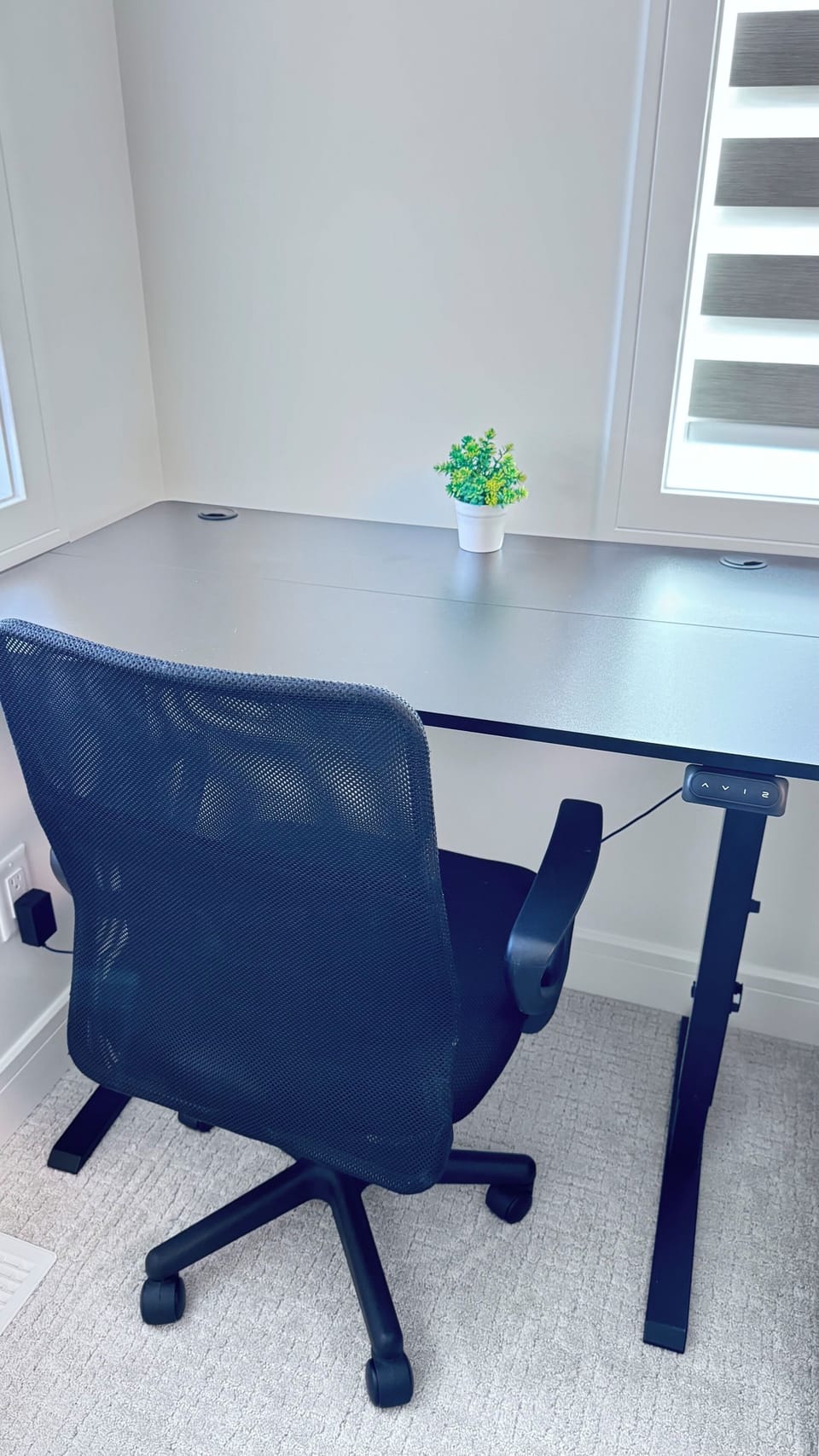 Bright, modern workspace with desk, office chair, and natural light