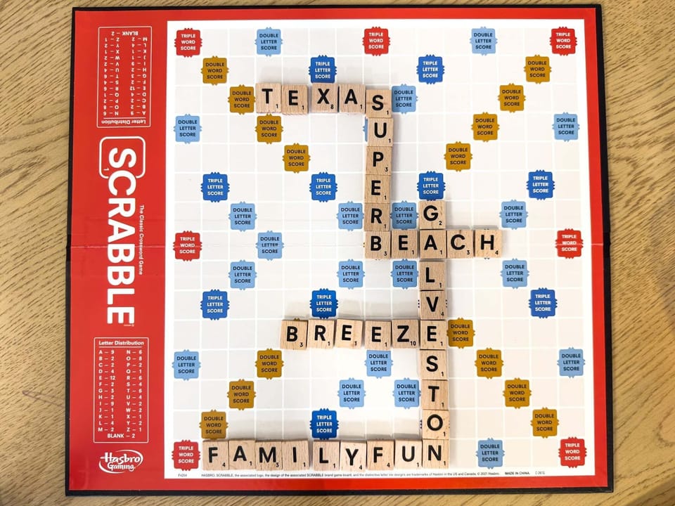 Scrabble board game setup in entertainment room offering family-friendly fun and indoor activities during your Galveston beach stay.